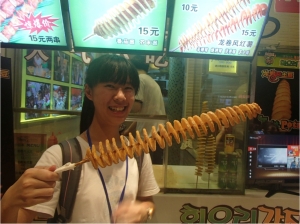 Figure 5. Grace with a neat fried potato snack at a mall in Shanghai.